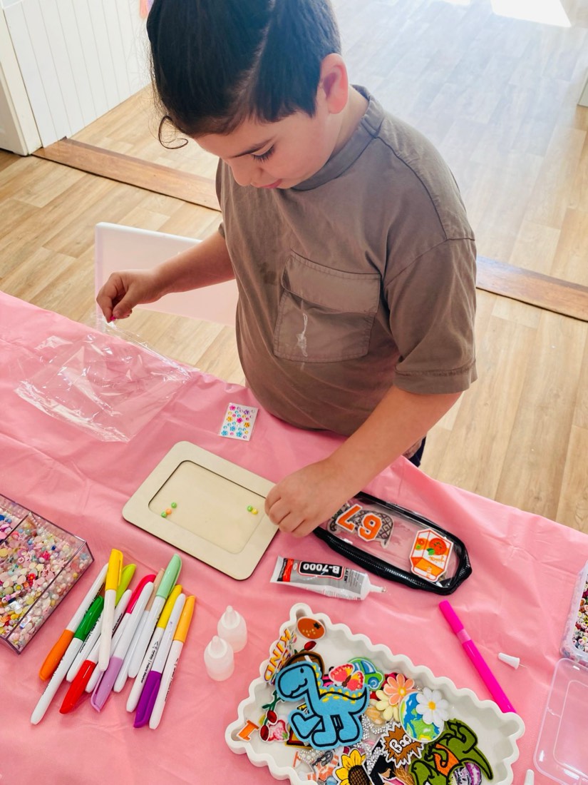 Boy decorating a wooden photo frame at the studio