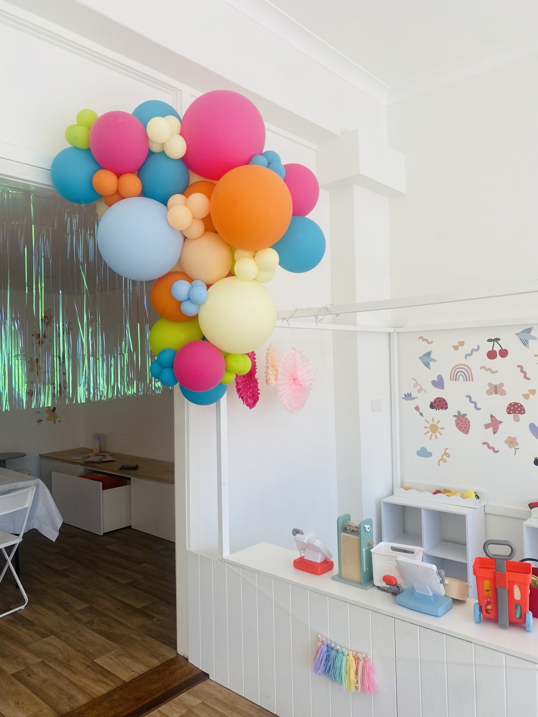 Balloon garland and play kitchen set up for a party