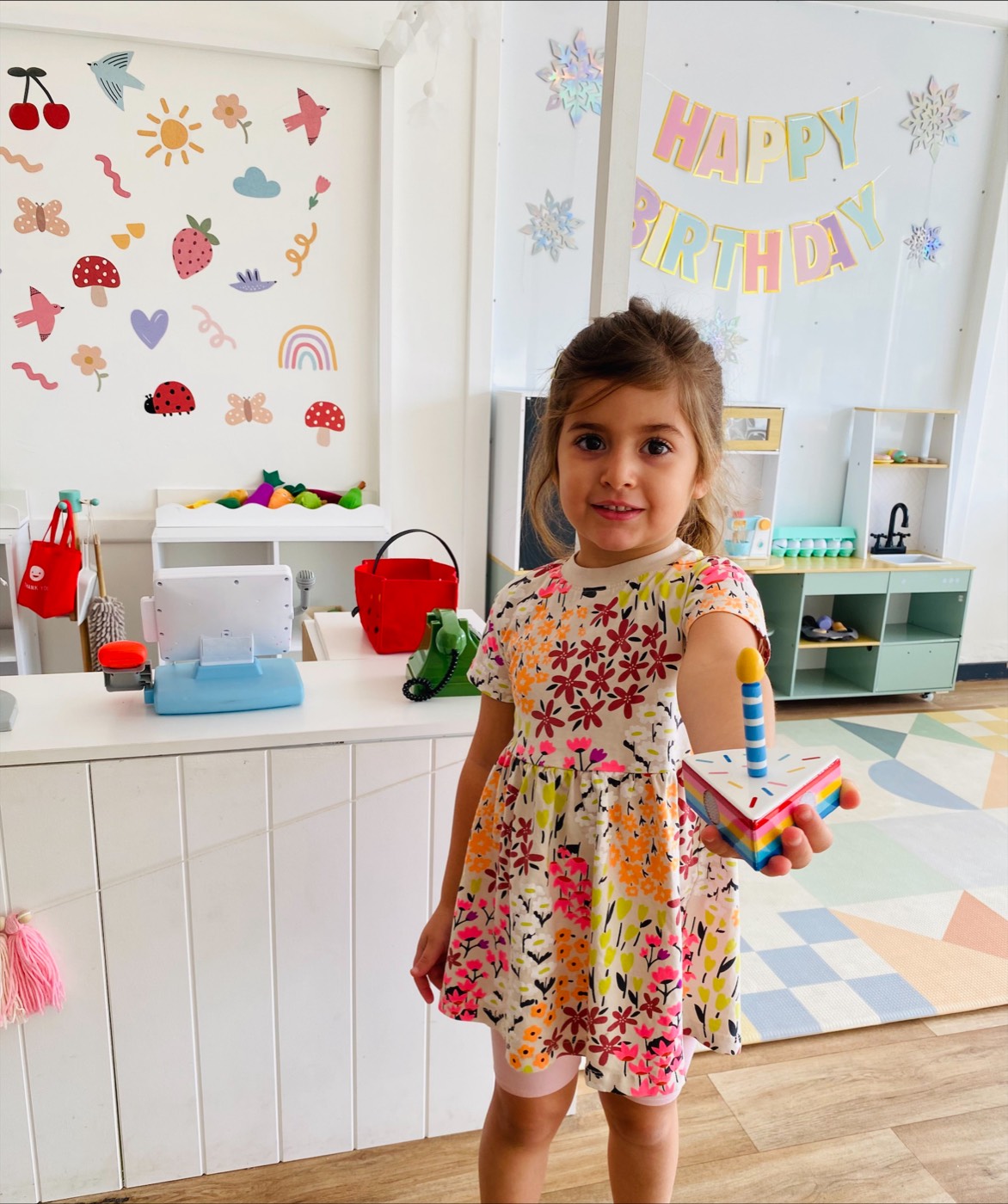 Birthday girl smiling in the B.Curious party room