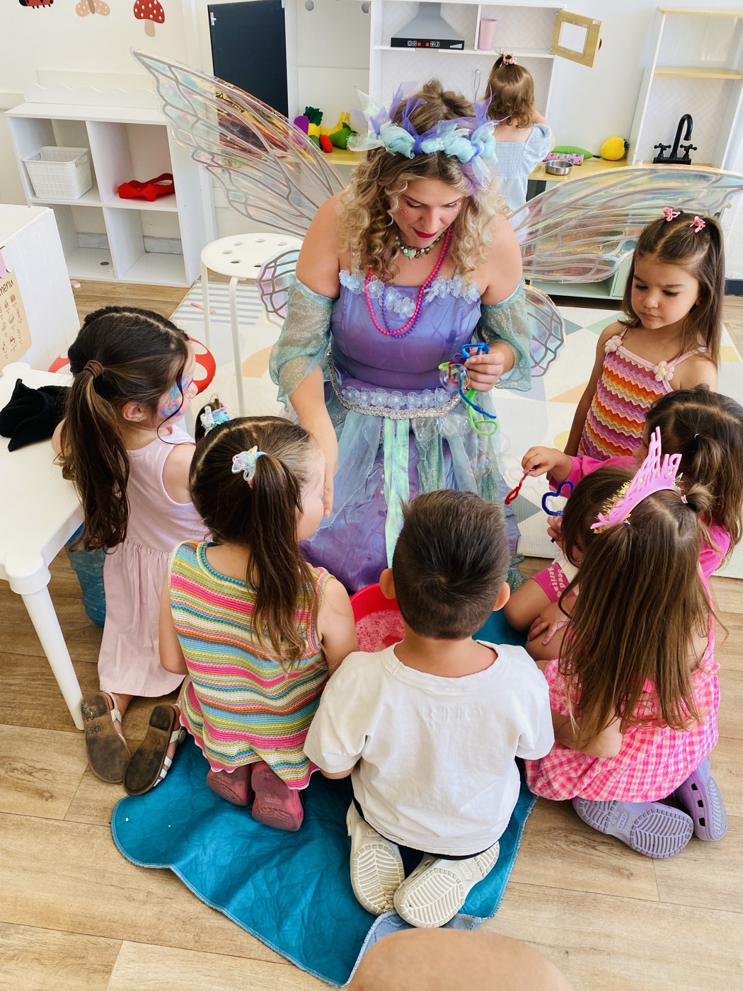 Fairy host with children sitting in a circle