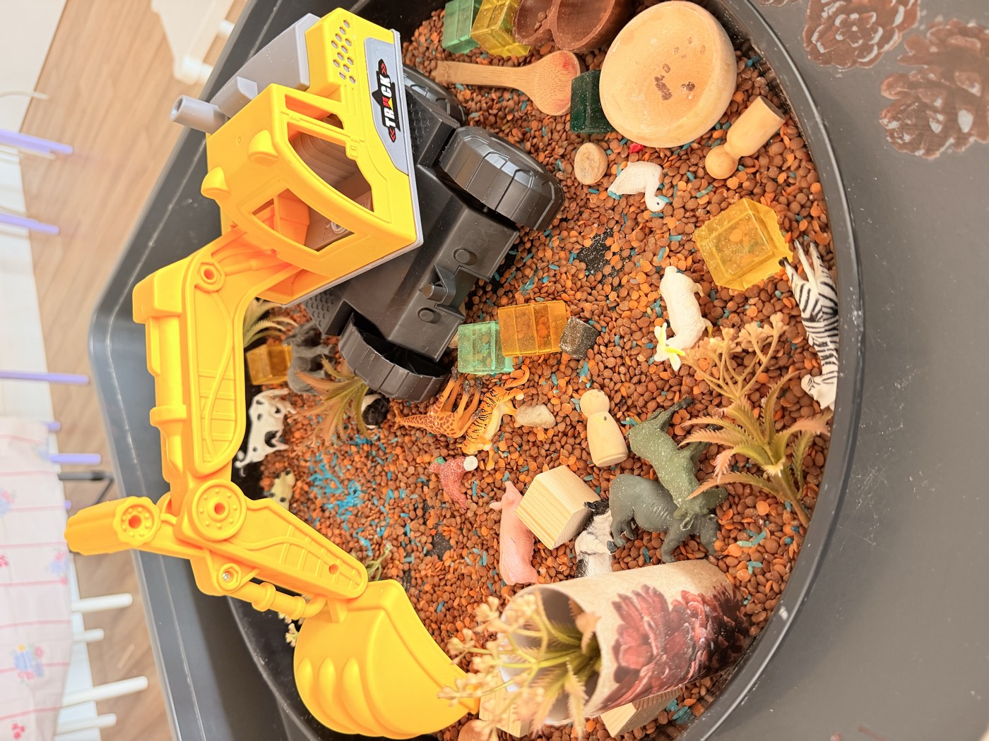 Top-down sensory tray with a digger, rocks and animals
